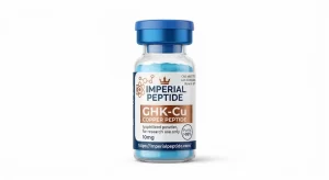Professional product photograph of a clear glass vial containing light blue GHK-Cu copper peptide powder, sealed with a blue flip-off cap on a white background.