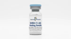 Professional product photograph of a clear glass vial containing GHRH (1–44) Analog Amide 2mg lyophilized peptide powder with a blue flip-off cap, displayed on a seamless white background.